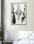 Framed black and white abstract artwork on a wall above a bed in a bedroom.