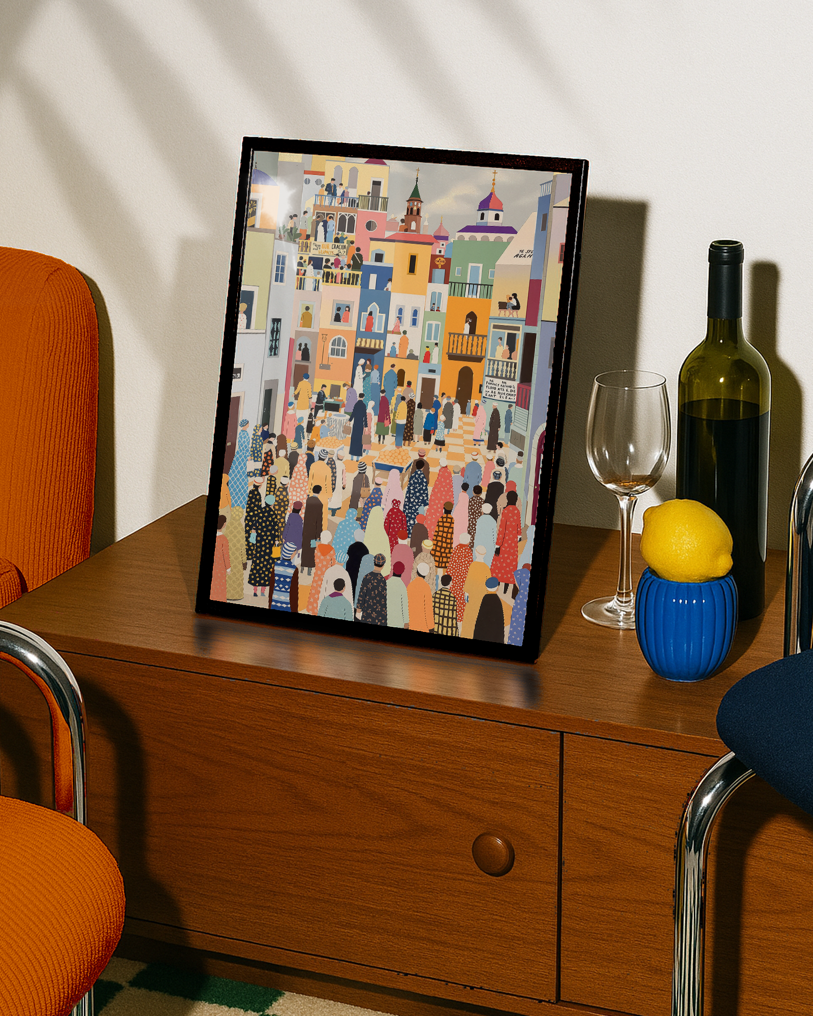 Framed artwork on a wooden side table with a bottle, glass, and lemon.