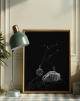 Framed artwork of celestial design on a wall in a room with decor elements.