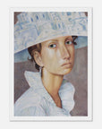 Framed artwork of a woman wearing a decorative hat with architectural patterns.