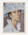 Framed artwork of a woman wearing a decorative hat on a white background