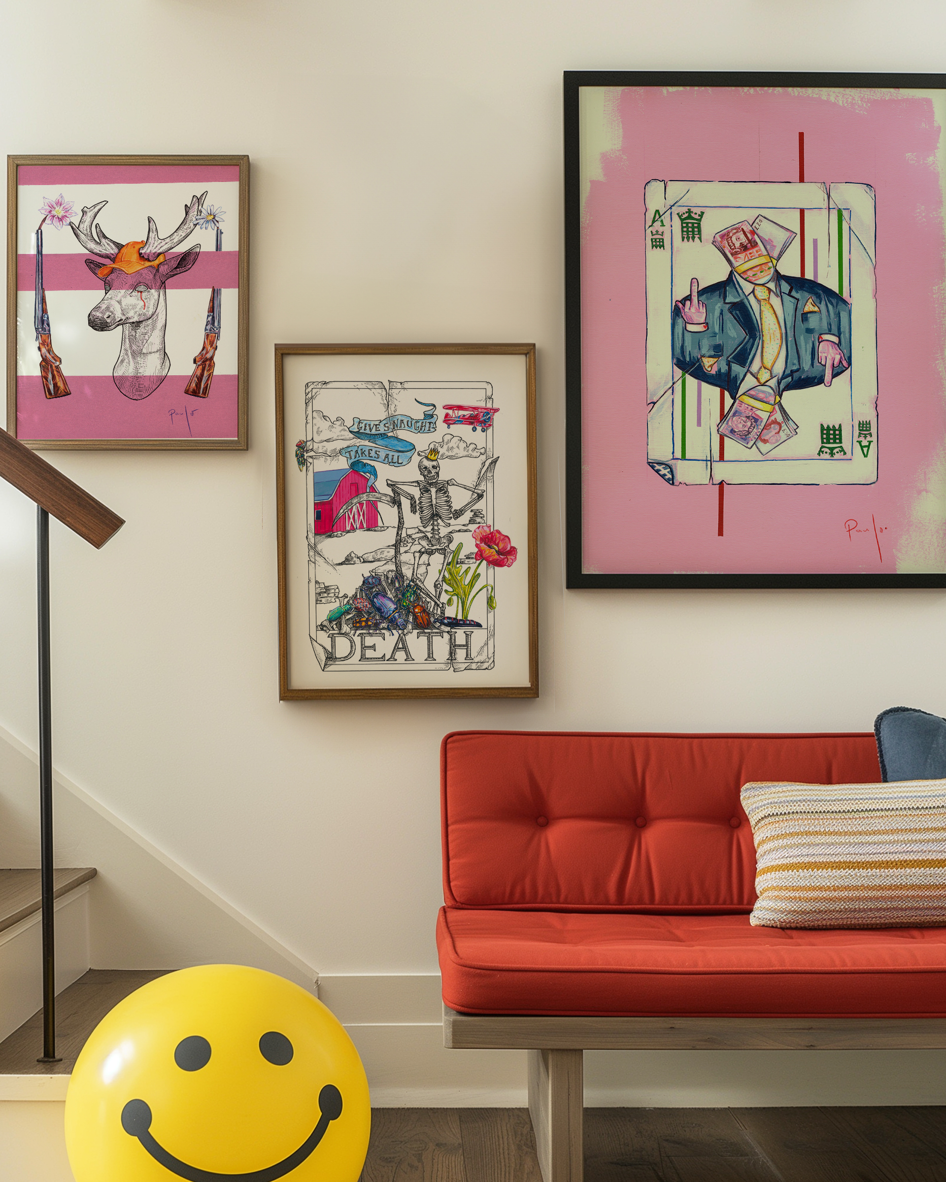 Colorful artwork on a wall with a red couch and yellow smiley ball in a room.