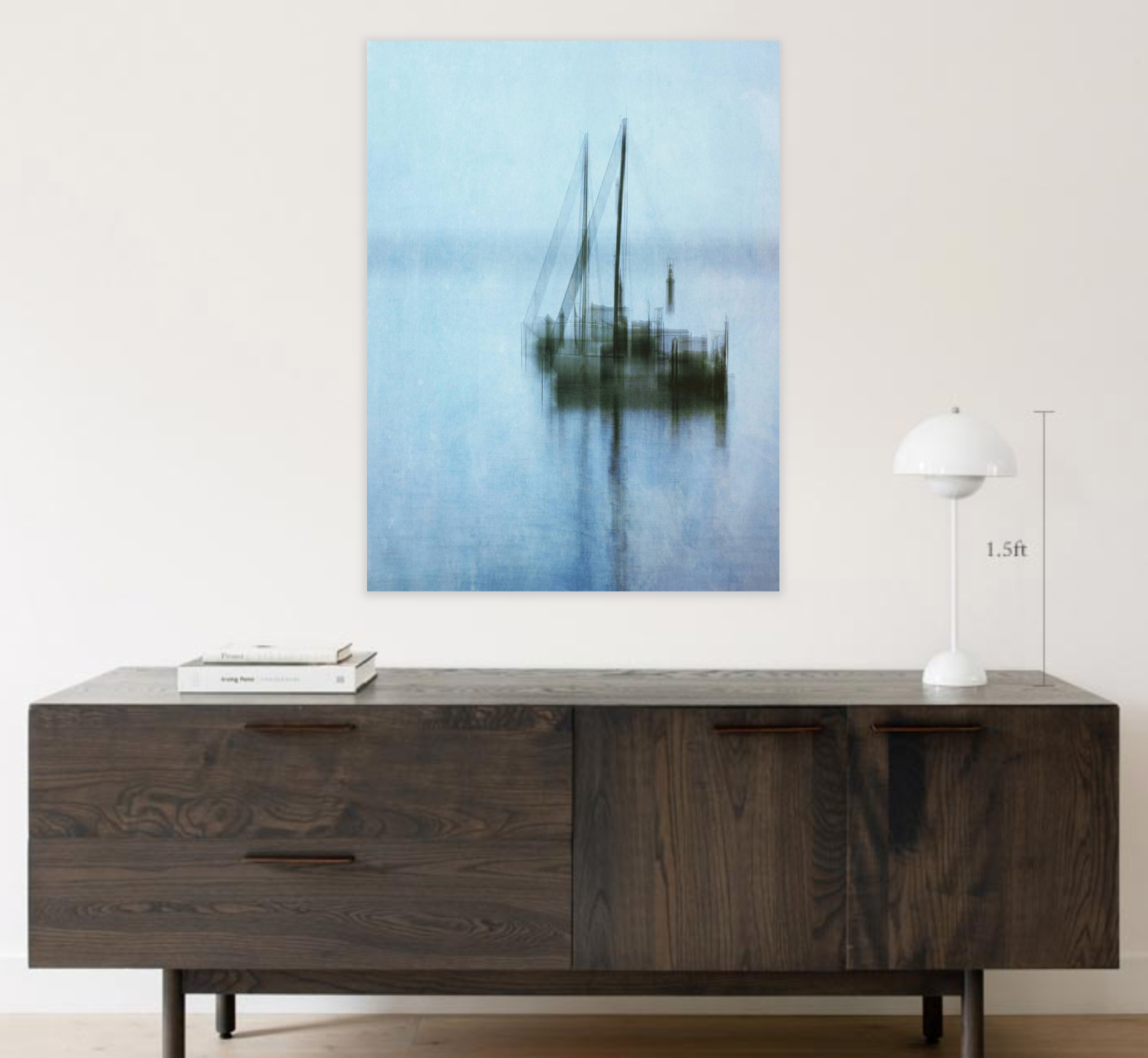 Wooden console table with a large abstract photo of a sailboat on a blue background.