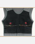 Fashion art print of a black sleeveless top with red floral embroidery on a white background