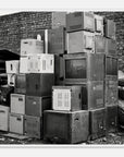 Ready to hang wall art of a stack of old electronic equipment against a brick wall in a white frame