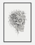 Framed artwork of a skull with flowers and plants growing out of it on a white wall.