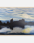 Framed artwork of caerphilly castle by a body of water with a blue sky.