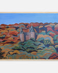 Framed artwork of a colorful landscape with a castle