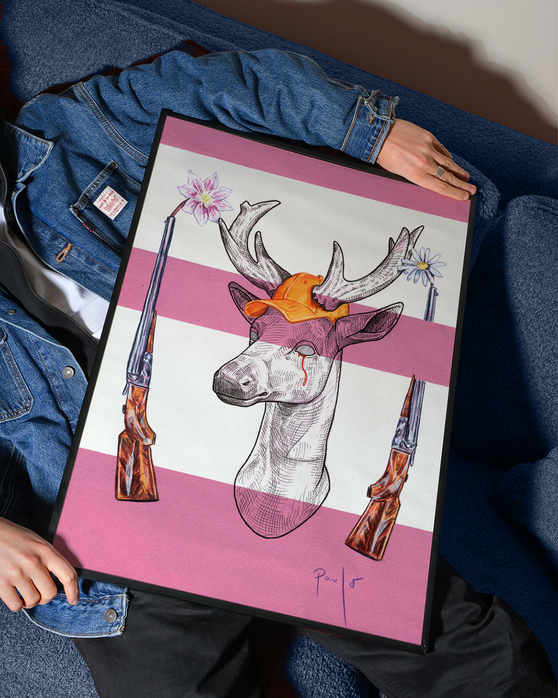 Person holding a framed artwork of a deer with a pink background