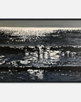 Framed artwork of ocean surface with reflections on a white background