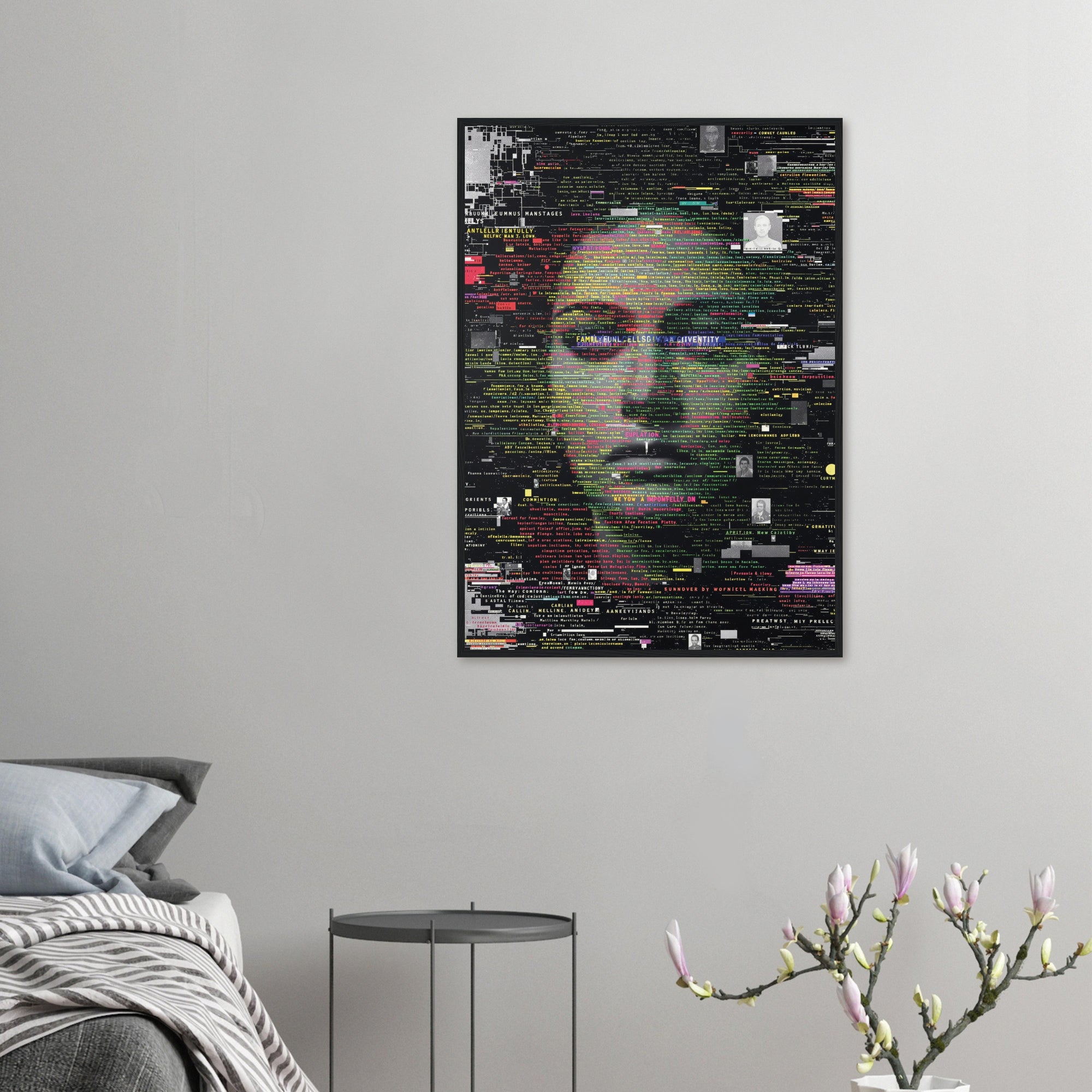 Framed poster with a stylized face design on a gray wall above a bed.