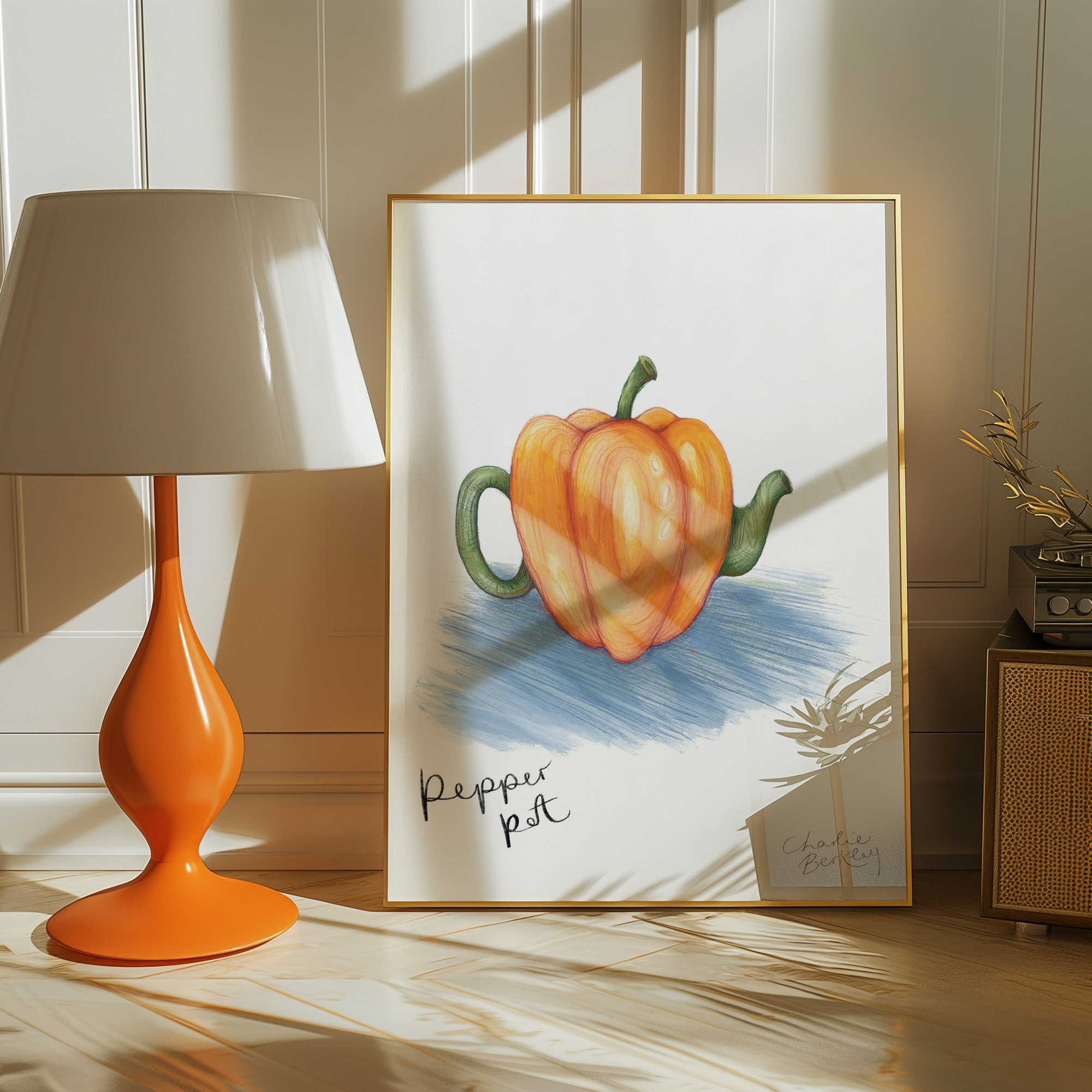 Framed artwork of a pepper pot with an orange lamp and wicker cabinet in the background.