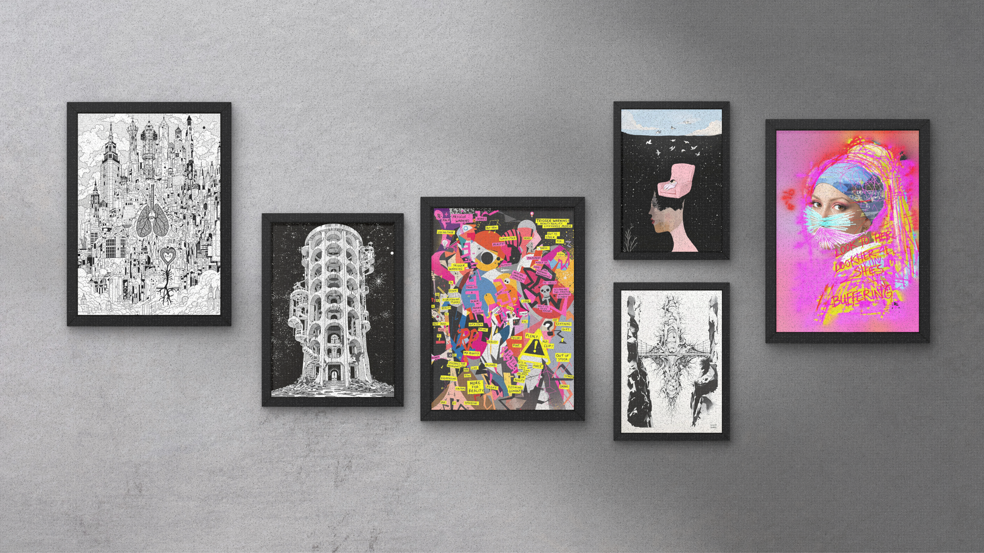 Collection of framed artworks on a gray wall creating a gallery wall