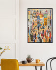 Colorful abstract art print on a white wall above a wooden table with chairs.