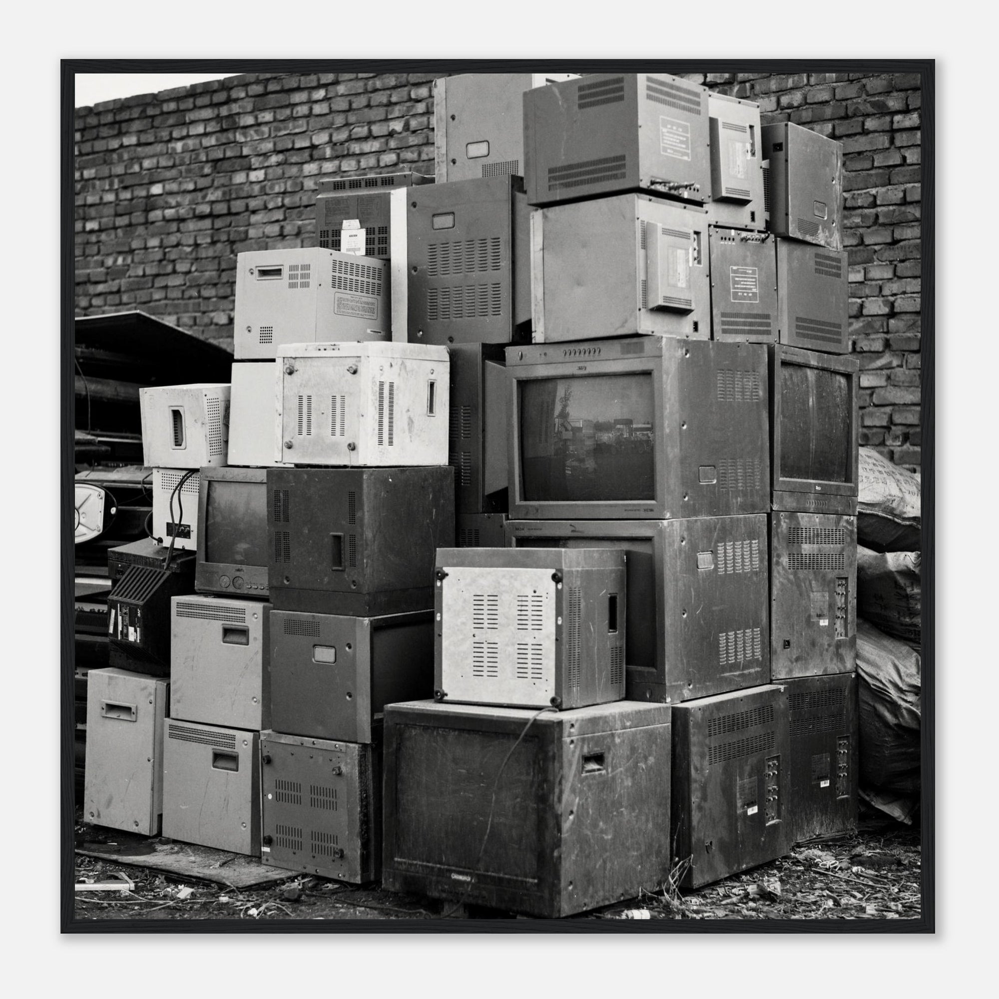 Art print of a photo of a stack of old electronic equipment against a brick wall
