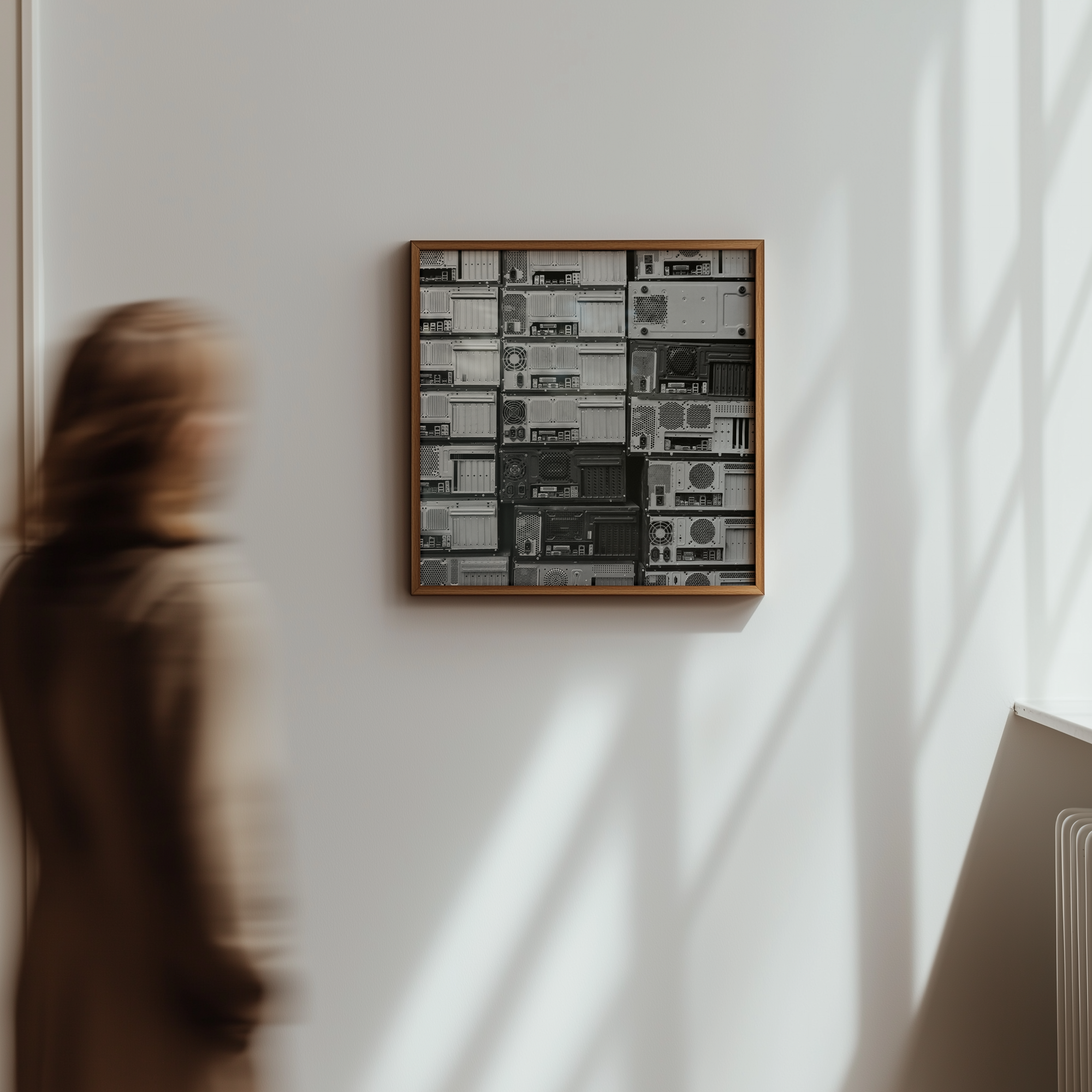 Framed artwork on a wall with a person partially visible in the foreground