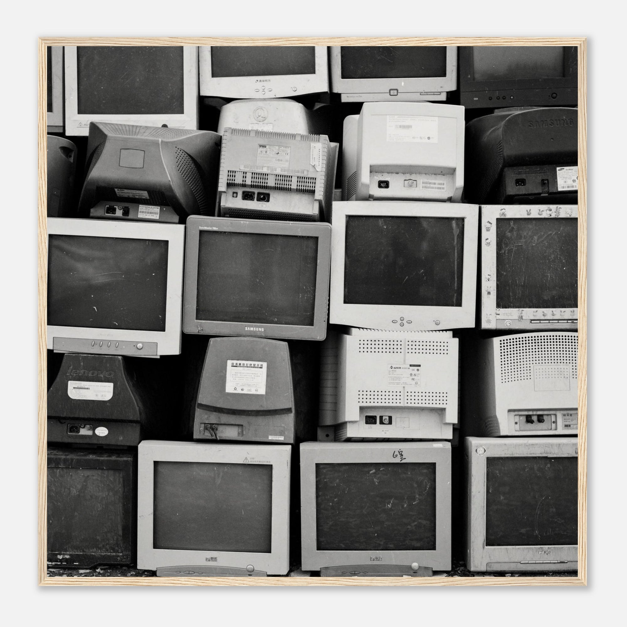Black and white photo wall art of a stack of vintage computer monitors in a wooden frame
