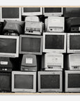 Black and white photo wall art of a stack of vintage computer monitors in a wooden frame