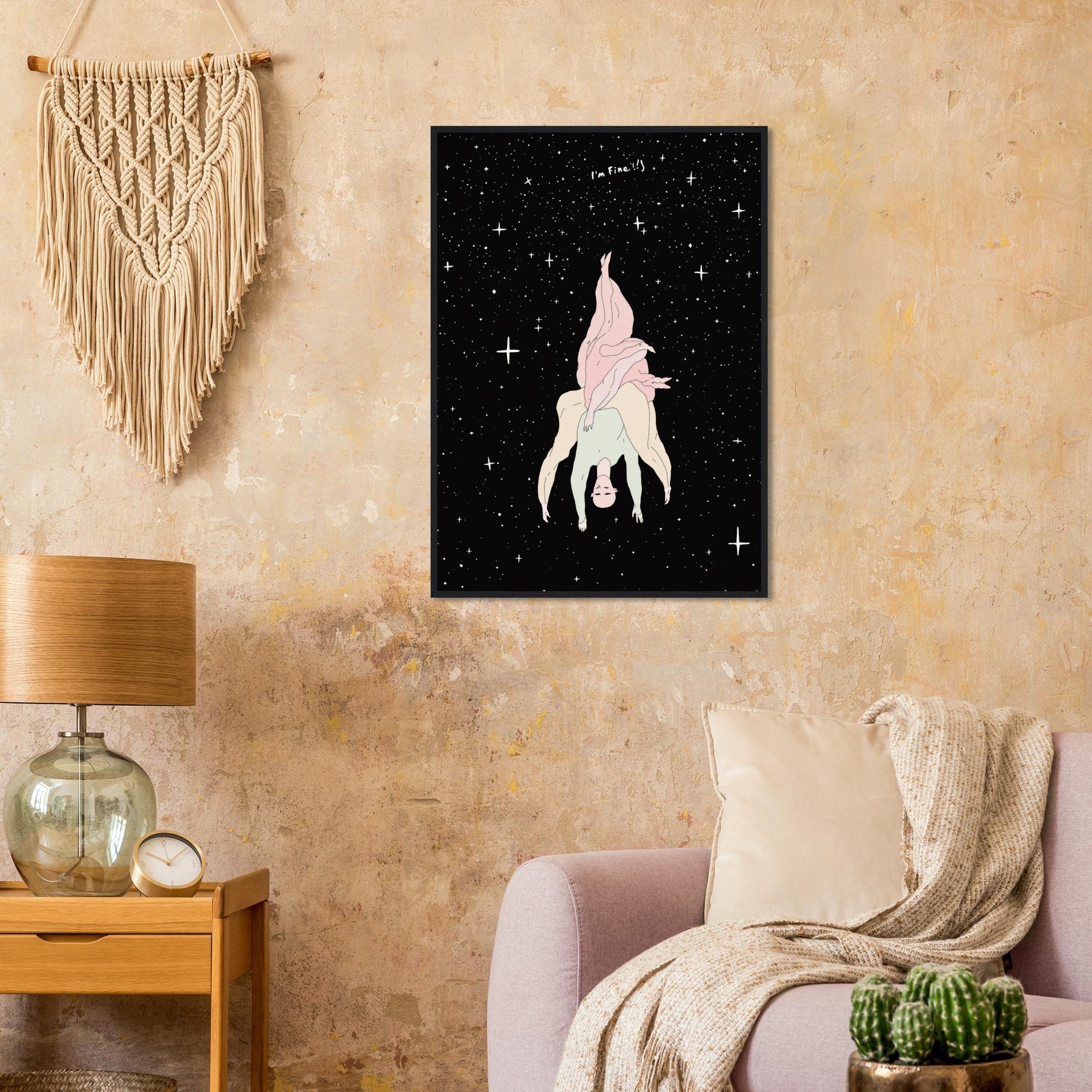 Framed artwork people in night sky with stars on a wall above a couch.