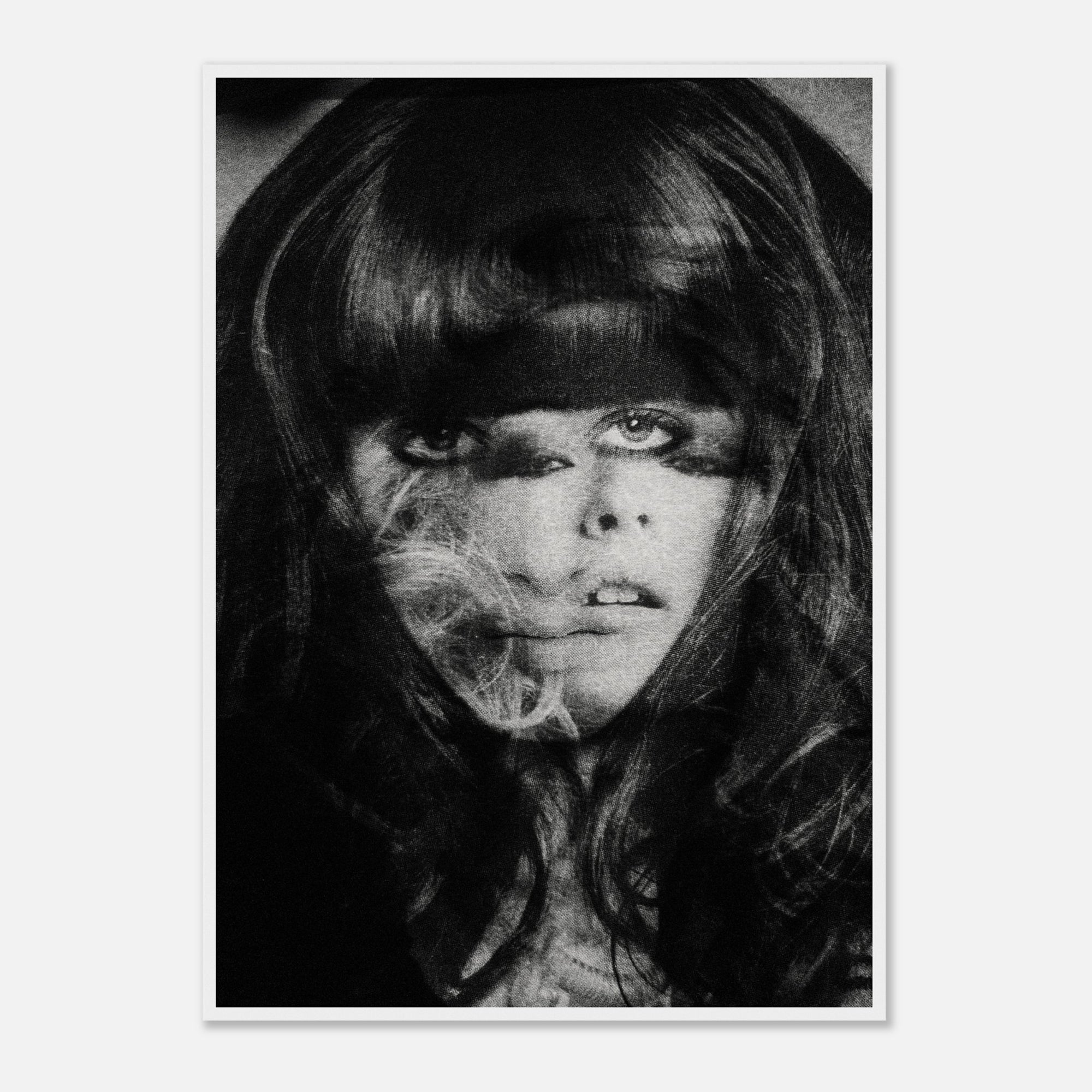 Black and white photo collage portrait of a person with long hair and makeup, framed.