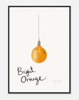 Framed artwork of a bright orange light bulb with 'Bright Orange' text on a white background