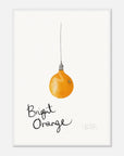 Framed artwork of a bright orange light bulb with 'Bright Orange' text on a white background in a white frame