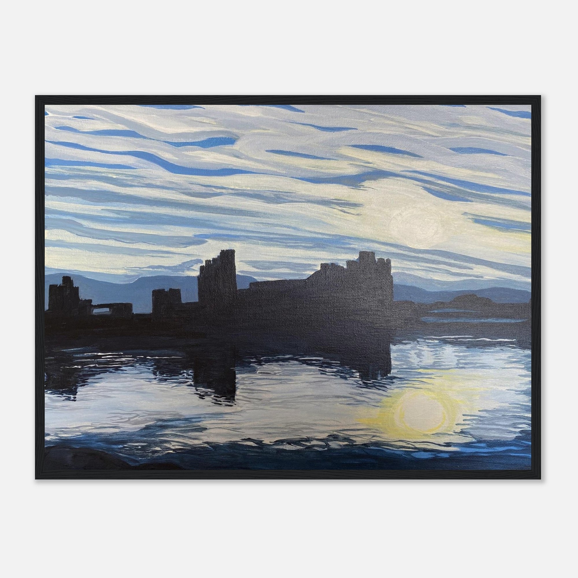 Framed artwork of caerphilly castle with a sunset over water