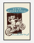 Framed poster with a design of a character on a motorcycle and text 'Extra-Terrestrial Customs' on a beige background.