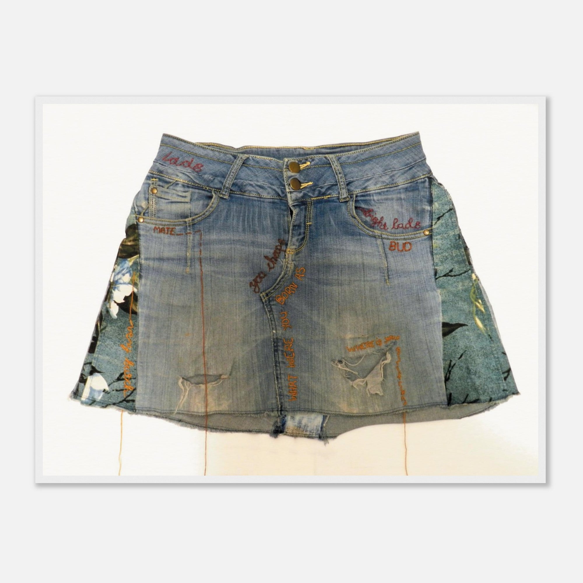 Framed art print of a denim skirt with patterns on a white background