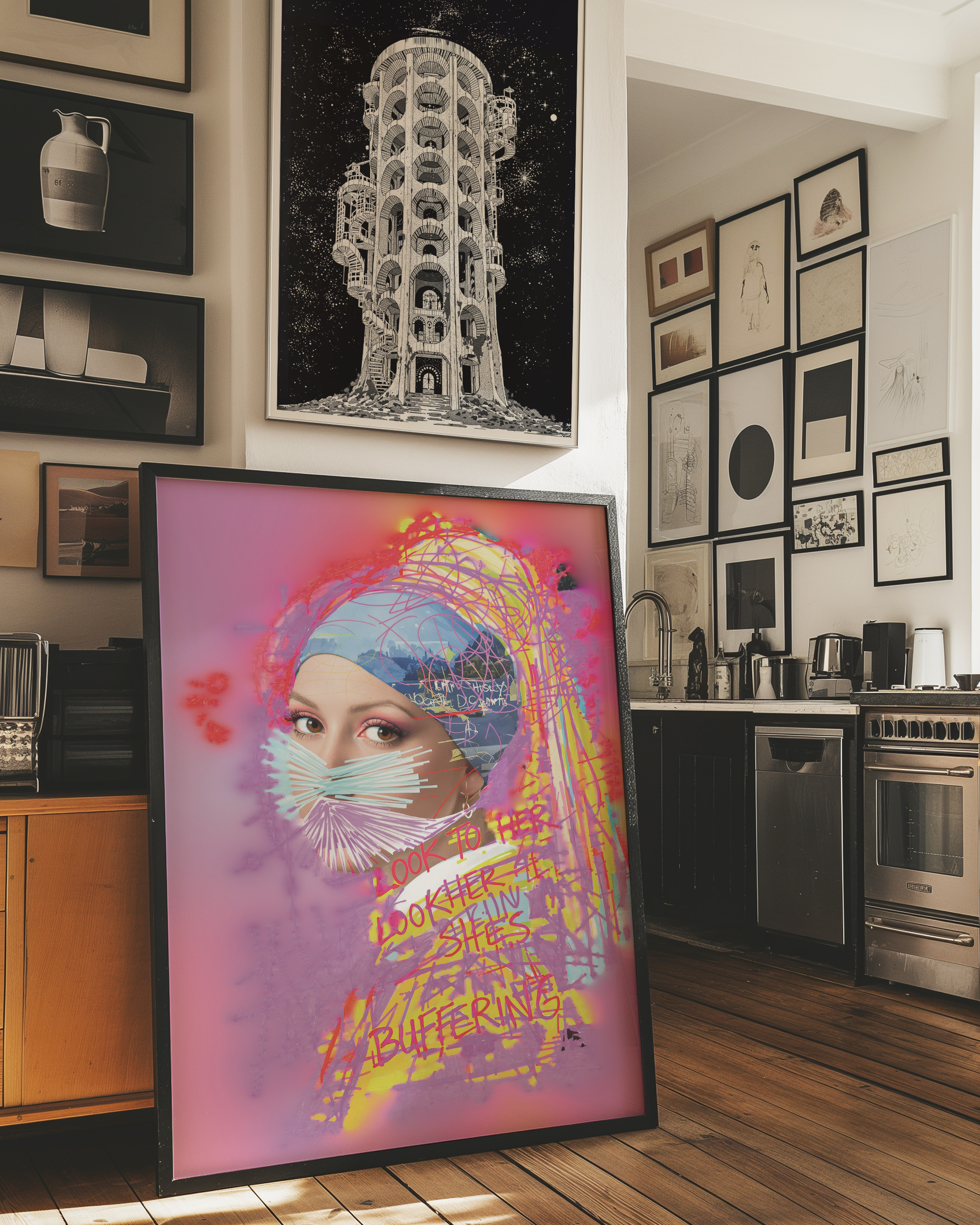 Framed colorful art print of a woman in a modern kitchen.