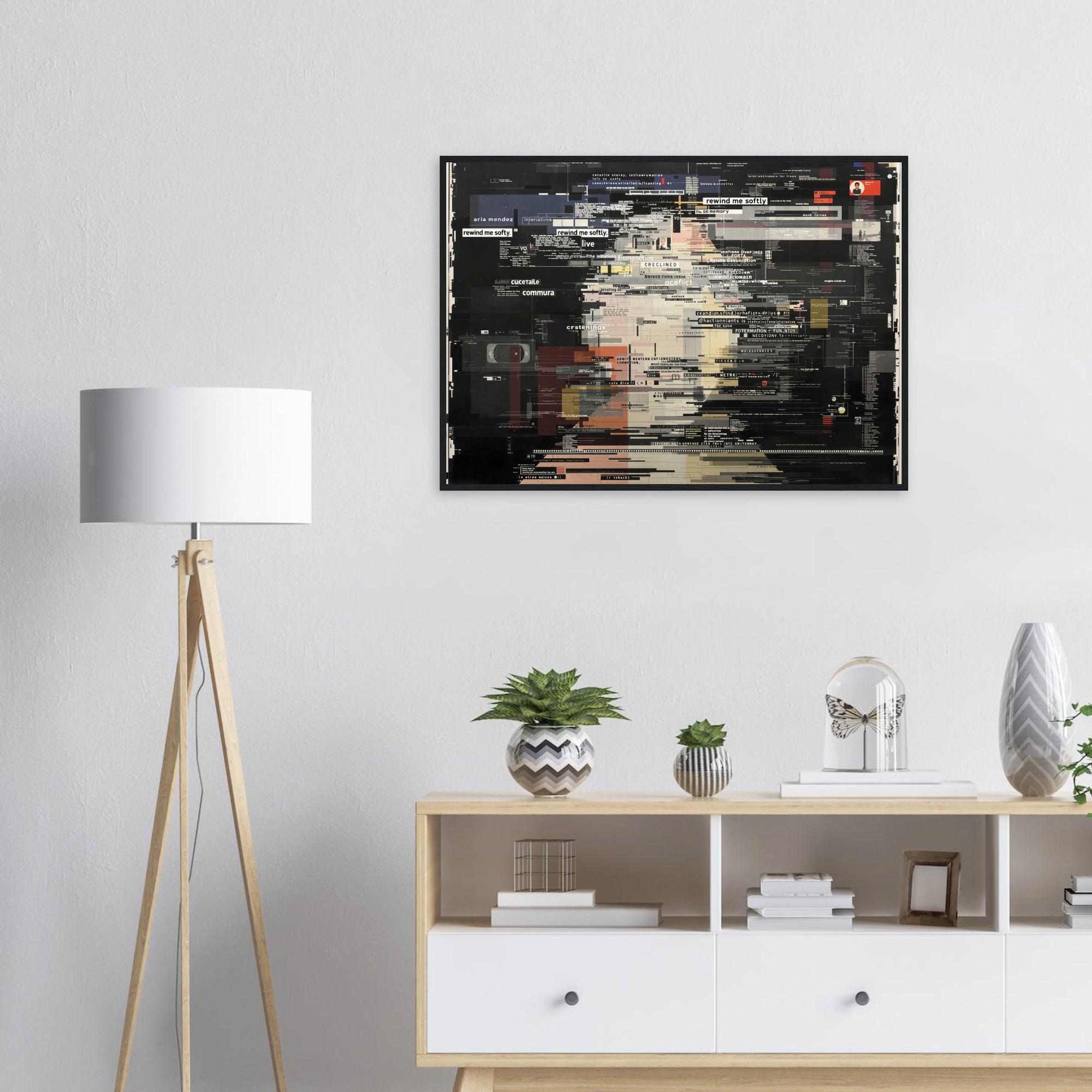 Black framed poster on a wall above a wooden shelf with decorative items.
