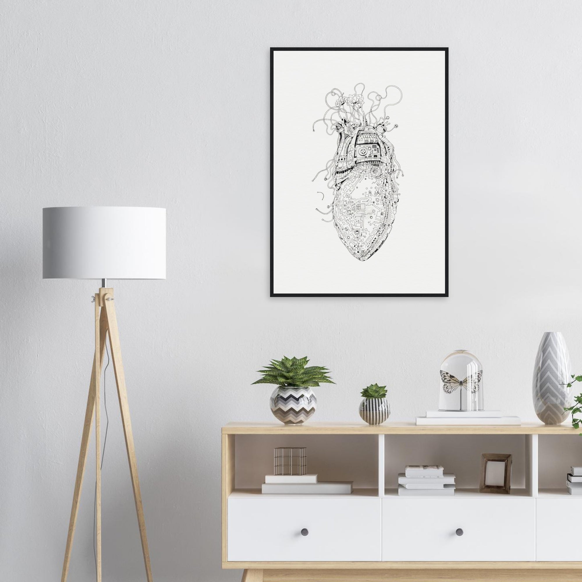 Framed black and white artwork on a wall above a wooden sideboard with decorative items.
