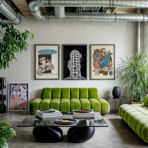 Framed unique art prints in a modern living room with green sofas, a glass coffee table, and vinyl records.