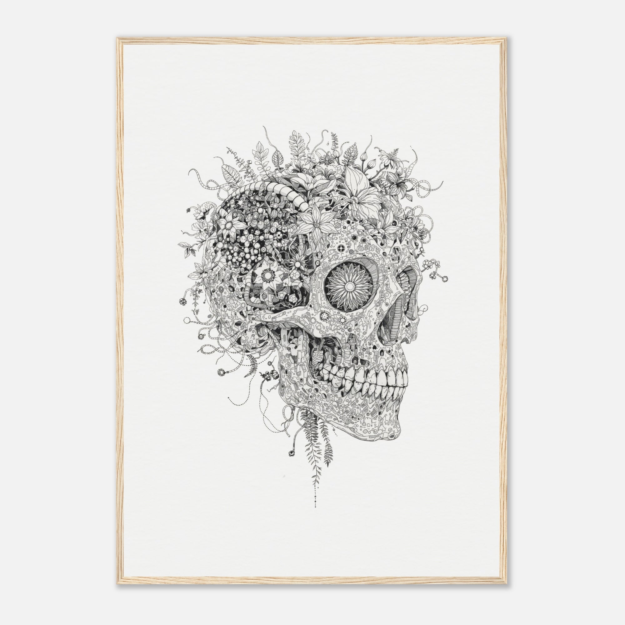 Framed artwork of a skull with flowers and plants growing out of it on a white wall.